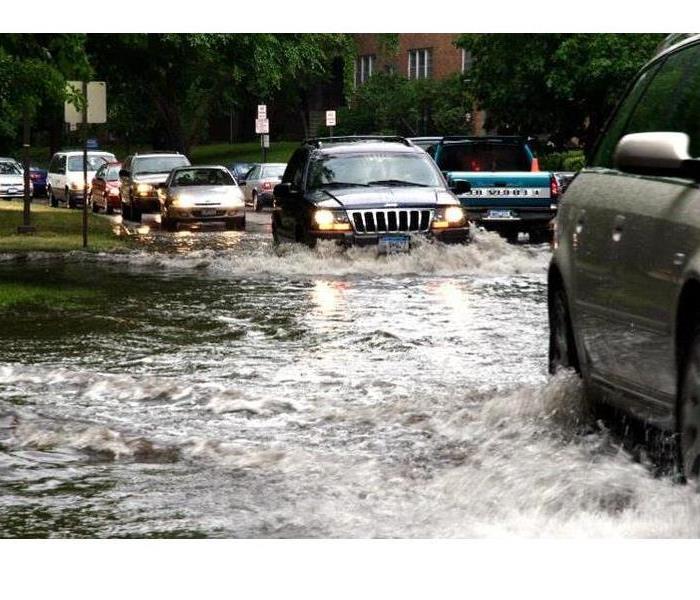 car driving through flood waters 