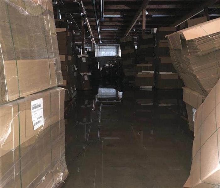 A Warehouse of boxes with water covering the floor